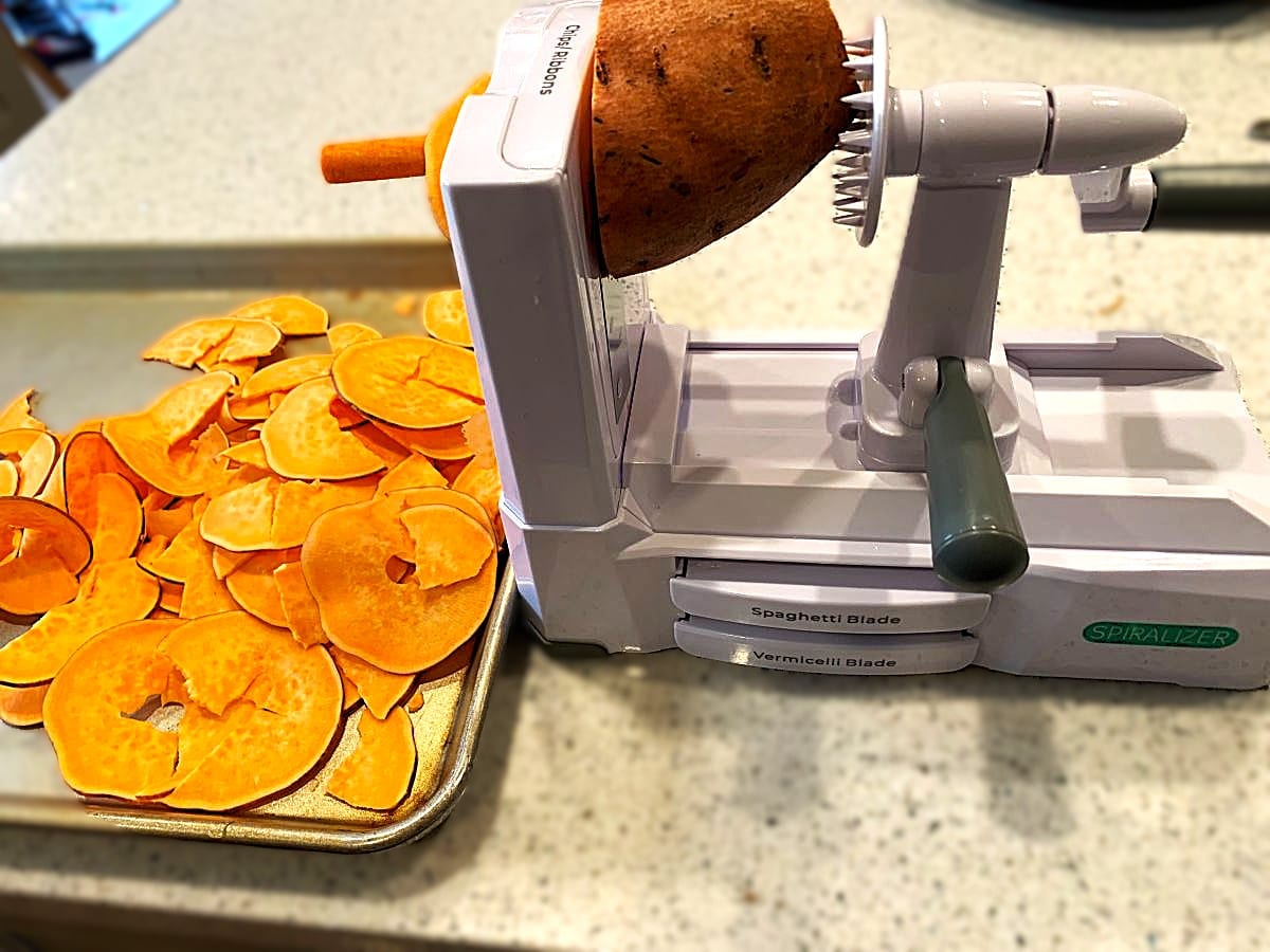 spiralizer being used to make sweet potato chips
