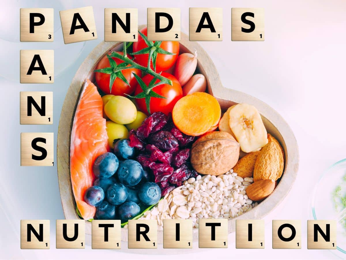 Heart-Shaped dish filled with colorful, anti-inflammatory foods with PANS & PANDAS Nutrition spelled in scrabble tiles